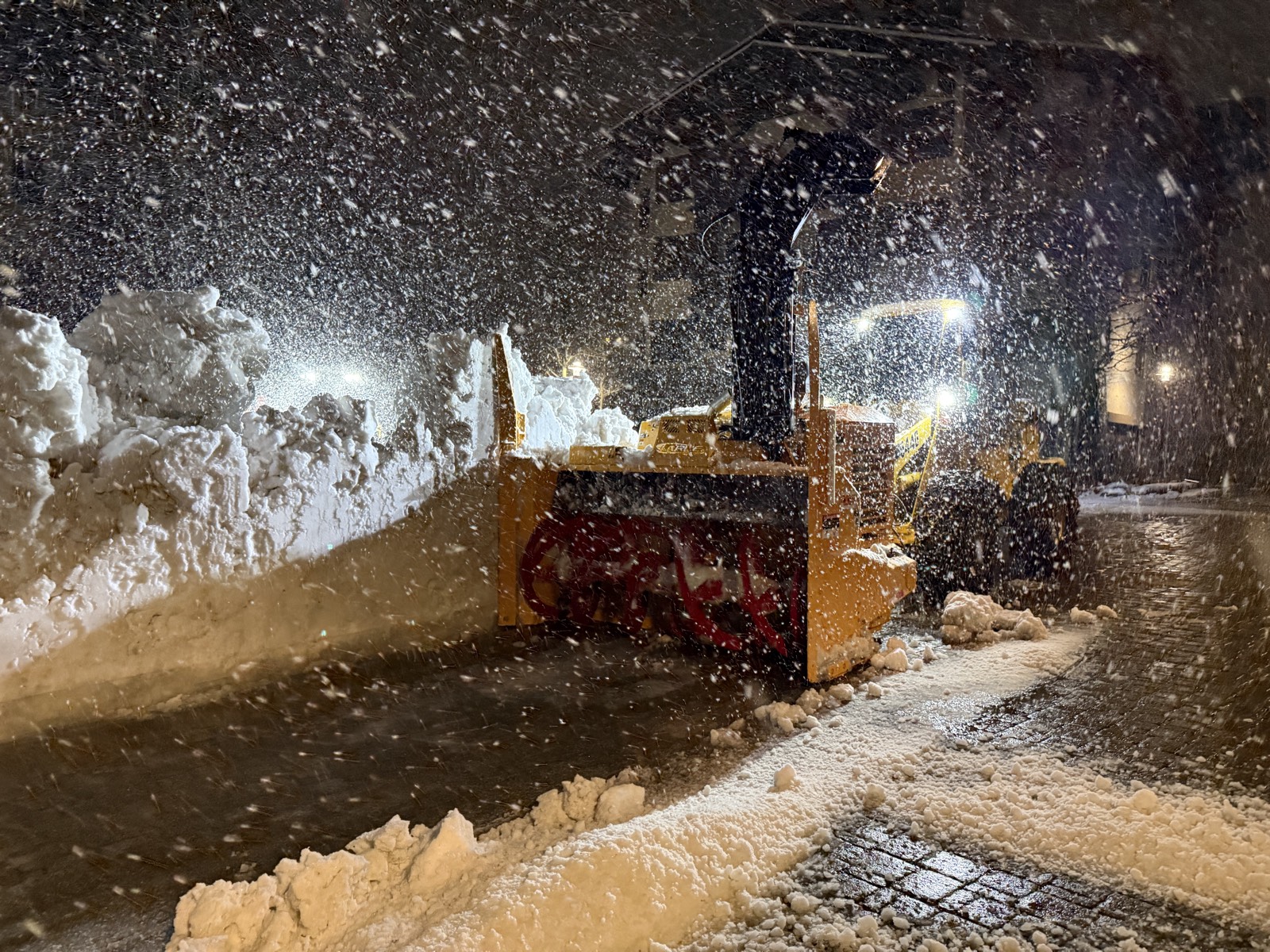 Snowblower operating at night during Palisades Tahoe snow removal