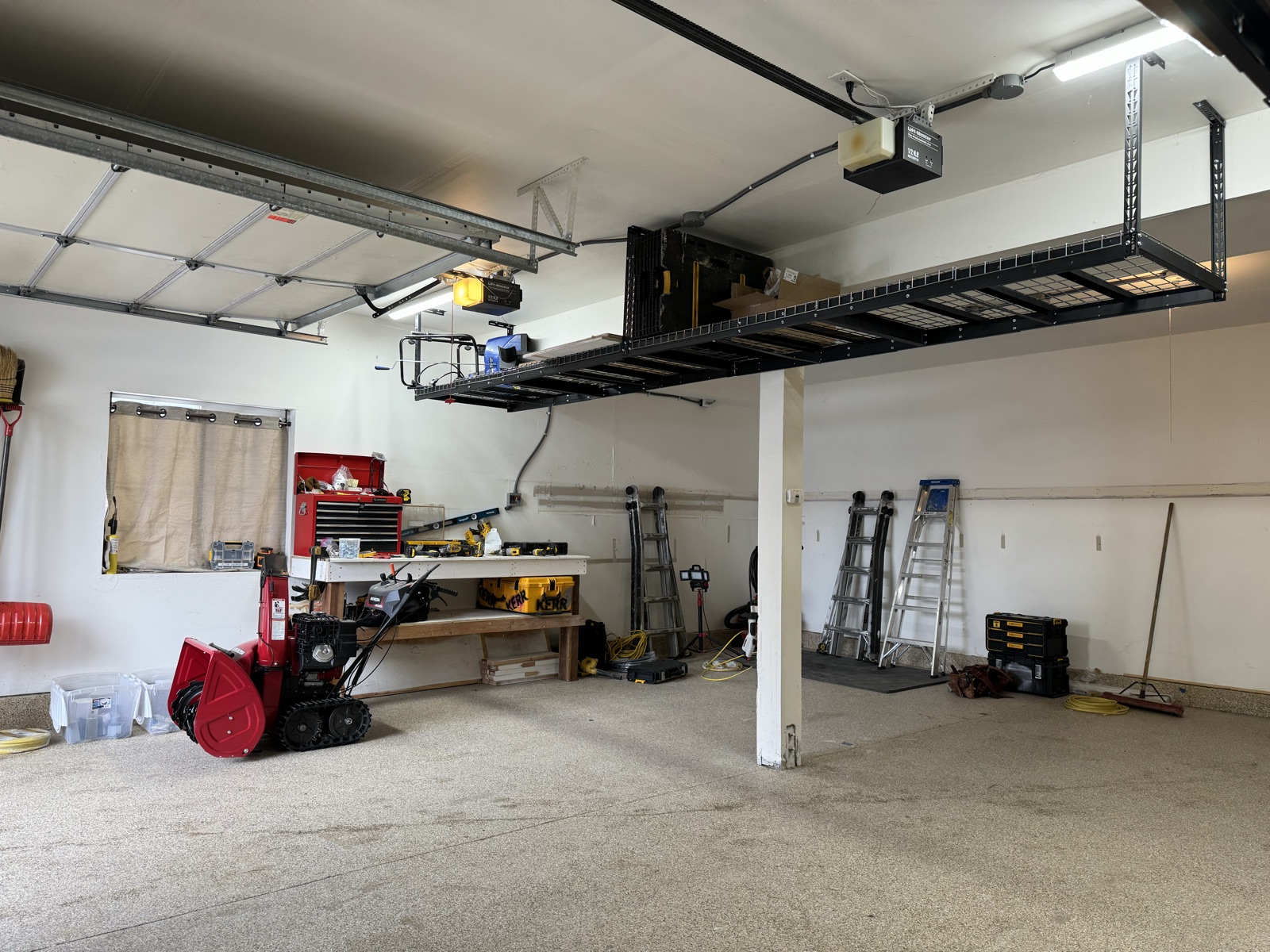 Empty garage interior, electrical roughed in, ready for the cabinet wall