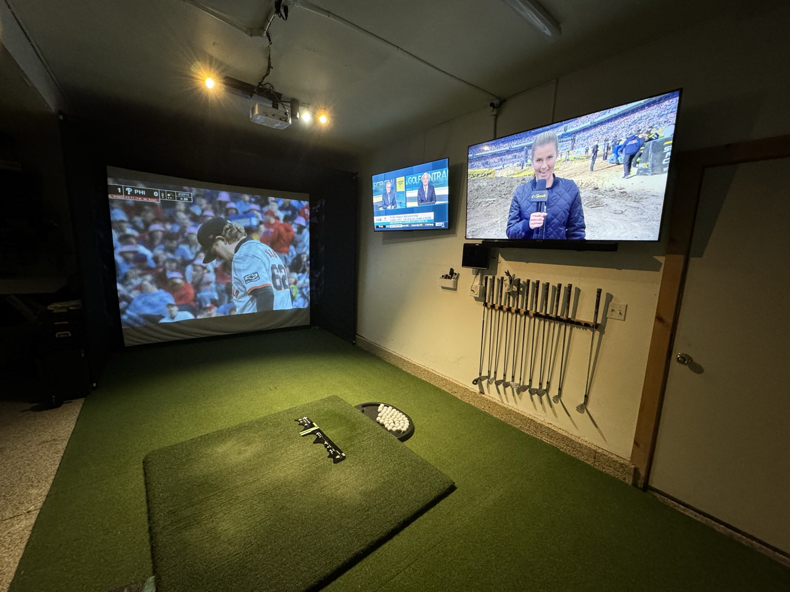 Mid-build workshop area showing the workbench and golf simulator coming together