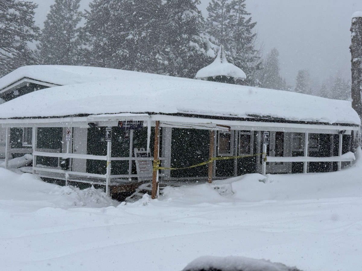 Palisades Tahoe Village during heavy snowfall — blizzard conditions at 6,100 feet elevation