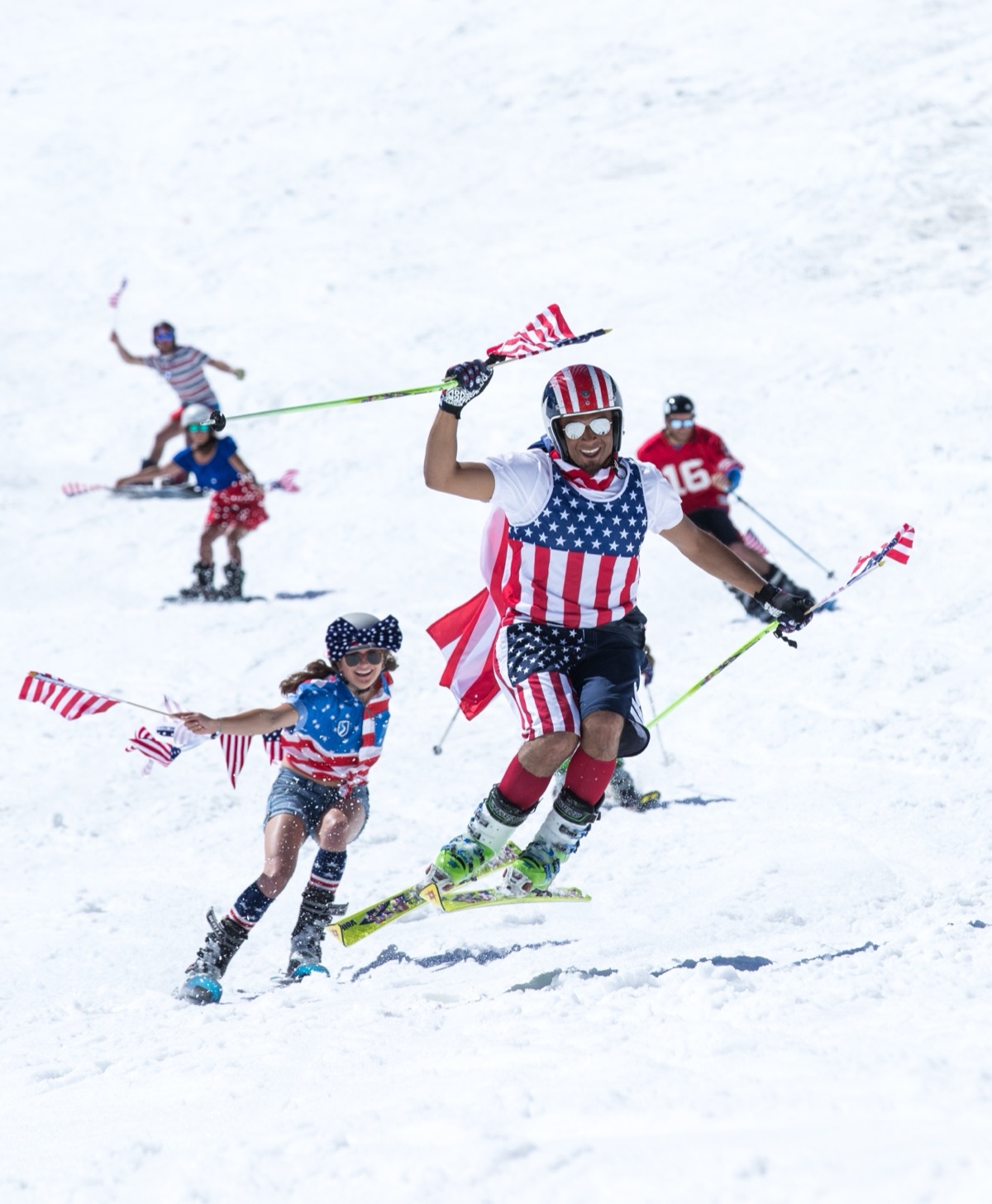 Errol leading a group down the mountain in full American flag gear at a Fourth of July ski event