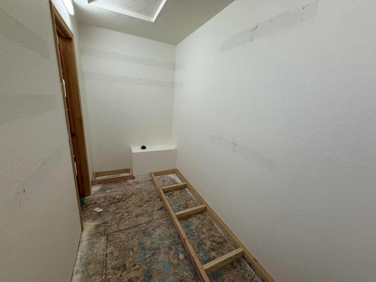 Closet interior prepped with floor framing for install