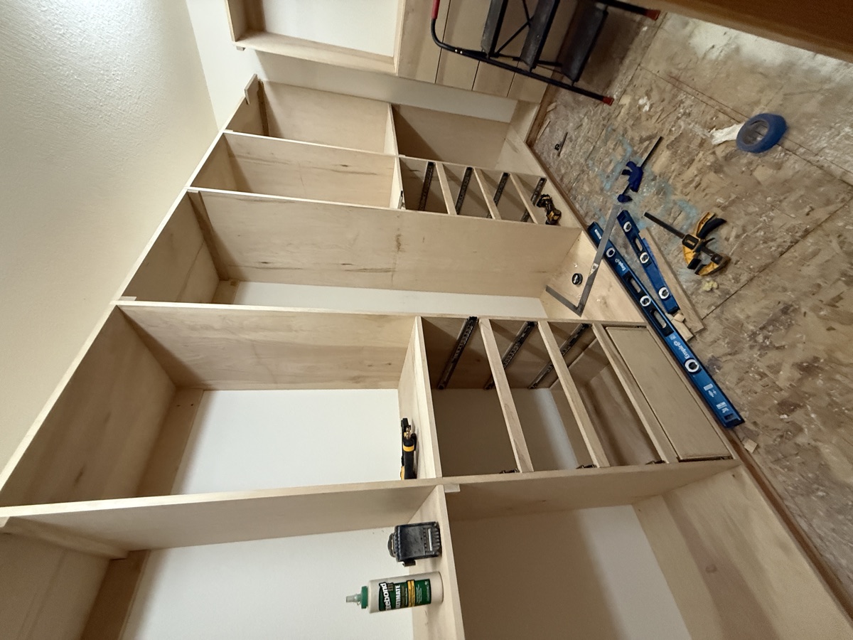 Shelving towers being installed in the walk-in closet