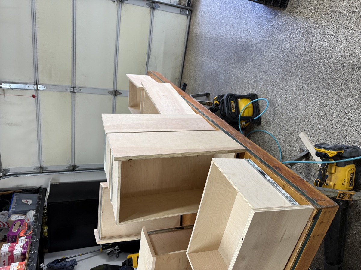 Multiple shelving towers lined up in the garage ready for install