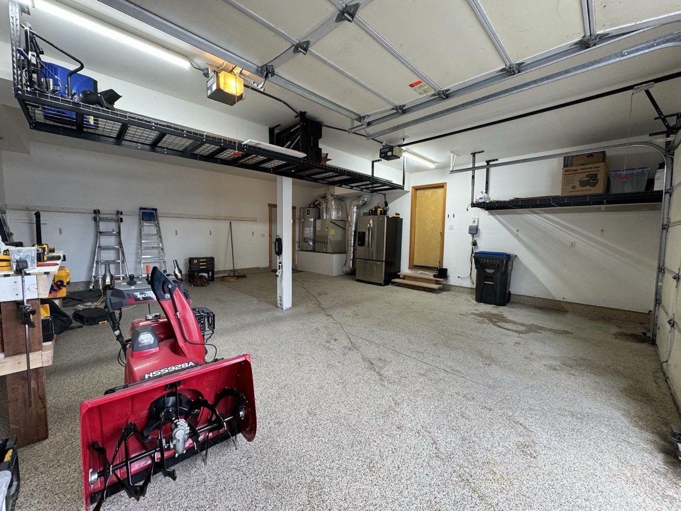 Snowblower storage clearance with ski racks above