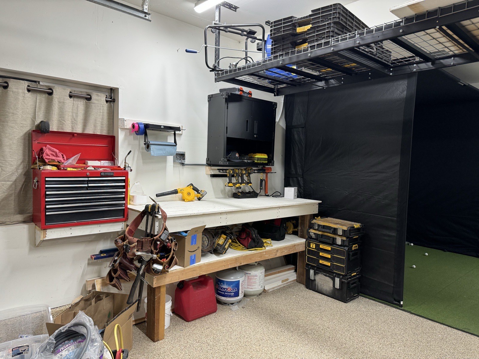 Garage workbench area with organized ski storage visible
